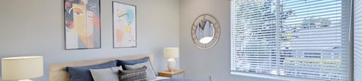 a bedroom with a bed and a large window