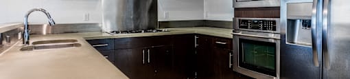 a kitchen with stainless steel appliances and wooden cabinets