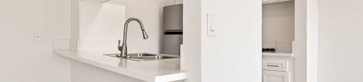 A kitchen with a sink and a dishwasher.