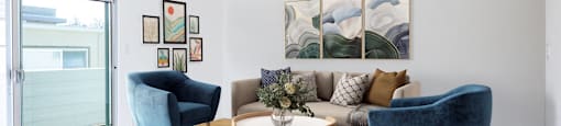 a living room with a couch and two chairs and a rug
