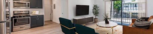 A modern living room with a green sofa and a television.