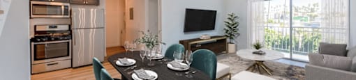 A modern dining room with a round table set for four.