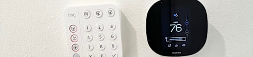 a clock and a remote control sitting on a wall