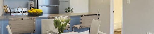 a kitchen and dining room with a table and chairs
