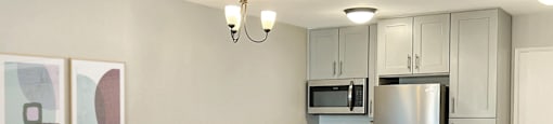 a living room and kitchen with a table and chairs