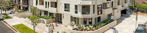 A large apartment building with a balcony on the second floor.