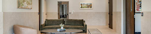 A living room with a couch, chair, and coffee table.