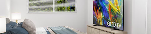 a bedroom with a bed and a tv in it
