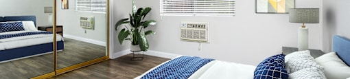a bedroom with a large bed and a mirror