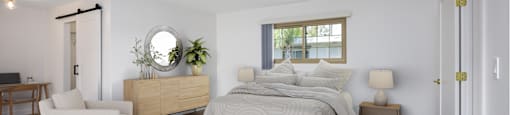 a white bedroom with a bed and a white rug