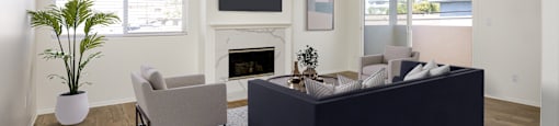a living room with a couch and chairs and a fireplace