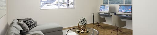 a living room with a couch and a desk with a computer