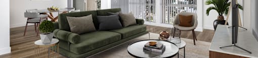 a living room with a green couch and a table