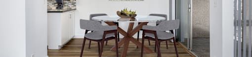 a dining room with a table and chairs and a ceiling fan