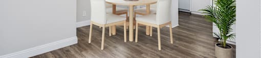 a dining room with a table and chairs and a kitchen