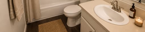 A bathroom with a marble shower and a white toilet.