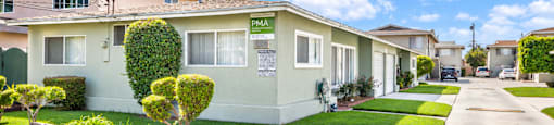 A row of houses with a sign that says "PMA" on the front.