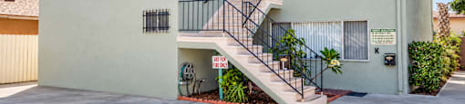 A two-story house with a balcony on the second floor.