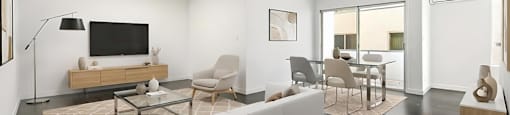 A modern living room with a white sofa and a glass coffee table.