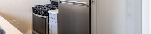 a kitchen with stainless steel appliances and a refrigerator
