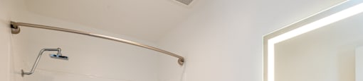 a bathroom with a shower and a sink and a mirror