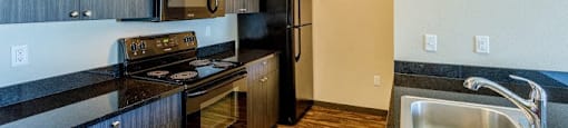 a kitchen with a stove microwave and sink