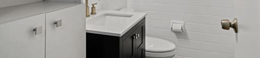 a bathroom with a sink and toilet in a 555 waverly unit