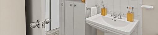 a small bathroom with a white sink and mirror