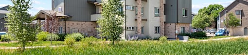 an apartment building with green grass in front of it