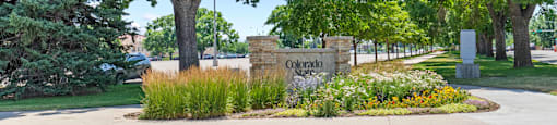 A sign that says Colorado in front of some trees.