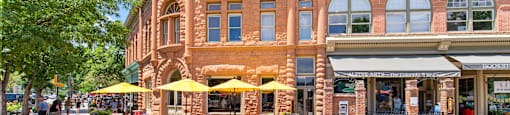 A street view of a building with a bakery on the ground floor.