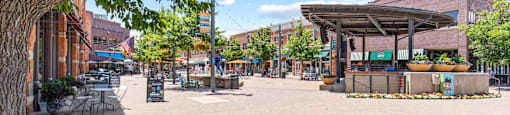 A sunny day at the plaza with a tree on the left.