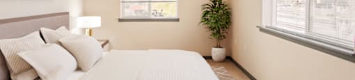 a bedroom with a large white bed and two windows