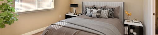 a bedroom with a large bed and a window