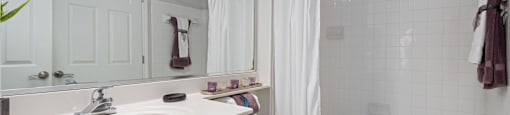A white bathroom with a toilet, sink, and bathtub.