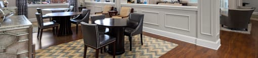 A large room with a long table and chairs.