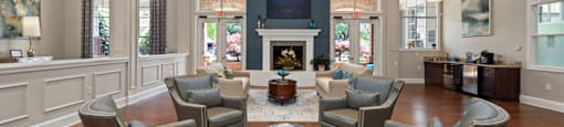 A living room with a fireplace and a large rug.