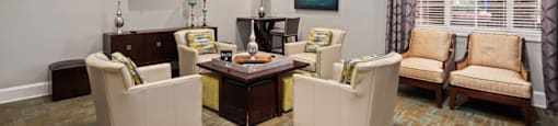 A living room with a sofa, armchair, and coffee table.