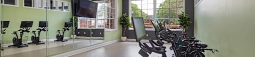 A gym with treadmills and exercise bikes.
