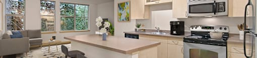 A kitchen with a bar area and a refrigerator.