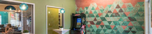 a game room with a foosball table and a 1960s arcade game