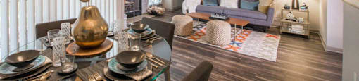 a living room and dining room with a table and chairs