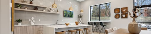 a kitchen and dining area with a table and chairs