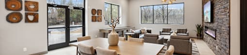 a dining room with a large table and chairs and a living room with couches