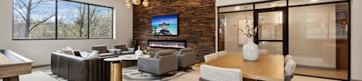 the living room and dining room in a modern home with a tv on the wall