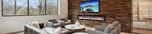 a living room with couches and chairs and a fireplace