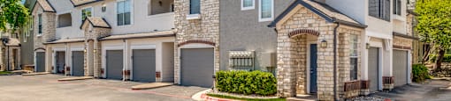 external view of a house with a driveway and garage doors