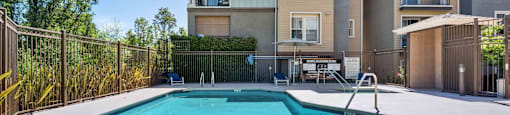 Apartments in Walnut Creek for Rent - Ivy Hill - An exterior shot of the swimming pool featuring a spa and blue lounge chairs