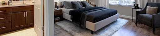 Pet-Friendly Apartments in Walnut Creek, CA - Ivy Hill - Spacious Furnished Bedroom with Gray Walls, Modern Wood Flooring, a Large Window, and a Ceiling Fan