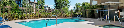 Swimming Pool With Spa and Blue Lounge Chairs